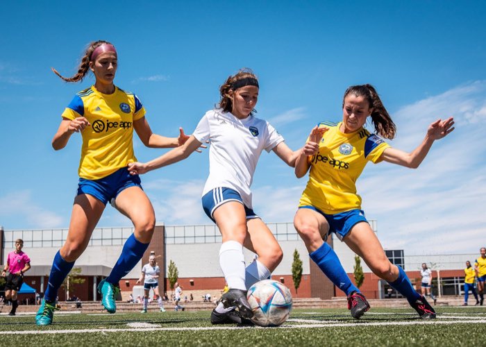 BURLINGTON, ON, Jun. 19, 2022: Players from Darby FC and Burlington SC battle for the ball during League1 Ontario regular season action.