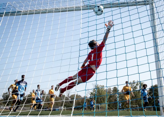 OAKVILLE, ON, Sep. 25, 2017: OAKVILLE, ON - Sep. 24, 2017: Dylan Roossien of the Cambrian Golden Shield fails to stop a free kick from Emilio Estevez of the Sheridan Bruins.