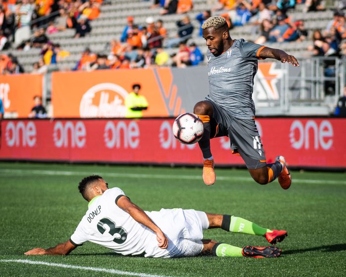 HAMILTON, ON, May 17, 2018: HAMILTON, ON - Oct. 6, 2019: Christopher Nanco of Forge FC jumps over Morey Doner of York9 FC in Canadian Premier League action.