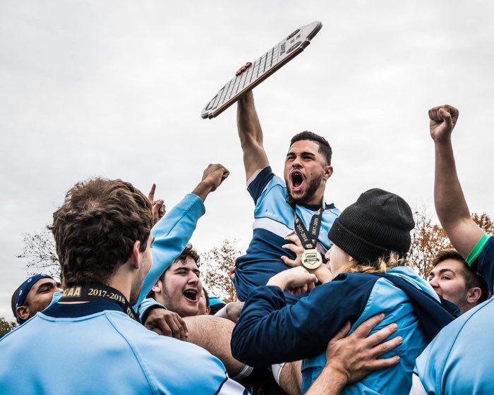 OAKVILLE, ON, Dec. 18, 2017: OAKVILLE, ON - Nov. 12, 2017: Jad Hamade of the Sheridan Bruins hoists the OCAA Men's Rugby Championship plaque into the air after a victory against the St. Lawrence Vikings.