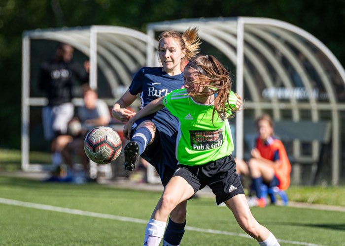 OAKVILLE, ON: OAKVILLE, ON - Jun. 23, 2019: Players battle for the ball during a League1 Ontario women's soccer game between the Oakville Blue Devils and DeRo United.