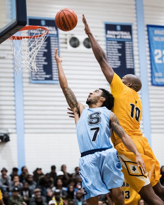 BRAMPTON, ON: BRAMPTON, ON - Feb. 4, 2017: Dylan Periana twists and turns for a lay-up in the 100th regular season meeting between the Sheridan Bruins and the Humber Hawks.