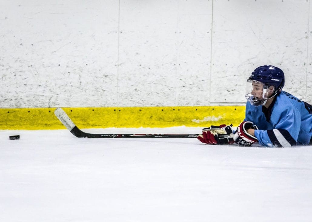 BURLINGTON, ON - Dec. 11, 2016: A Penguins player stretches to pass the puck while on the ice.