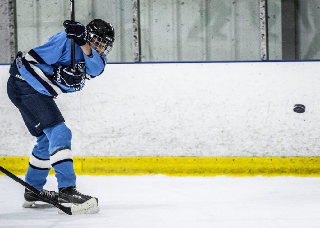 BURLINGTON, ON - Dec. 11, 2016: A Penguins player ices the puck in Wave Sports hockey action against the Canucks.