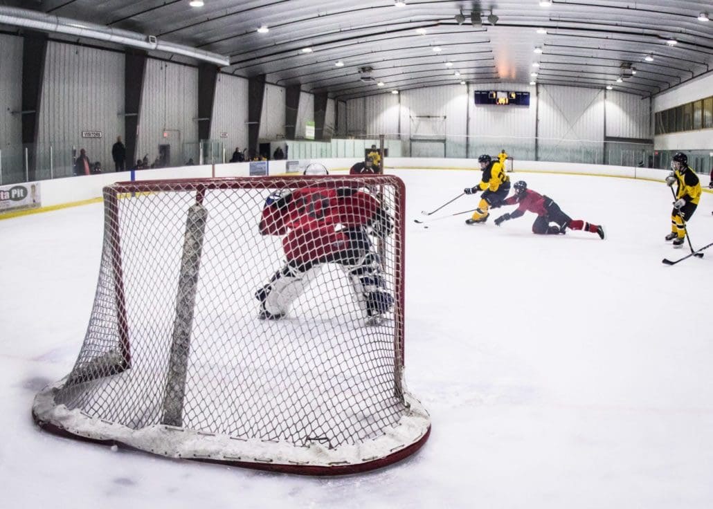 BURLINGTON, ON - Dec. 11, 2016: Players lunge for the puck in Wave Sports hockey action.