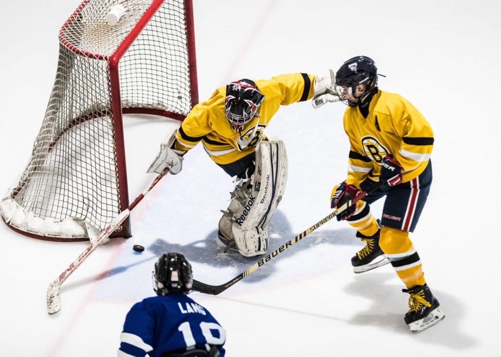 BURLINGTON, ON - APR. 8, 2017: The puck takes a strange bounce off the boards in Wave Hockey Championship action.