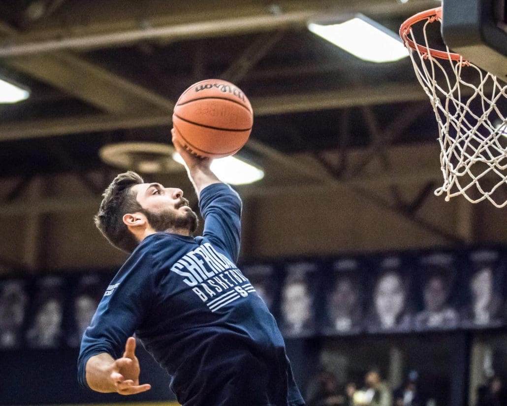 TORONTO, ON - Nov. 12, 2016: James Carlin of the Sheridan Bruins reaches for a dunk in warm-ups against the Humber Hawks.