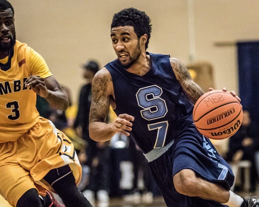 TORONTO, ON – Nov. 12, 2016: Dylan Periana of the Sheridan Bruins drives to the hoop against the Humber Hawks.