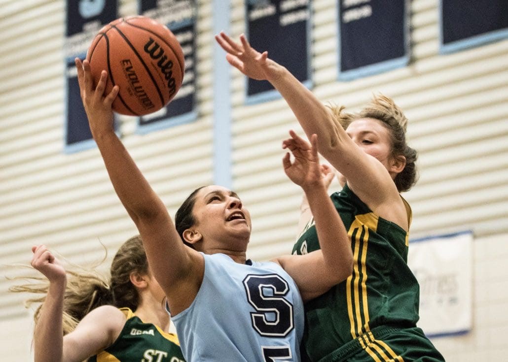 BRAMPTON, ON – Nov. 26, 2016 – Sheridan Bruins player Jaslin Khera is nearly blocked by a St. Clair Saints defender while stretching for a lay-up.