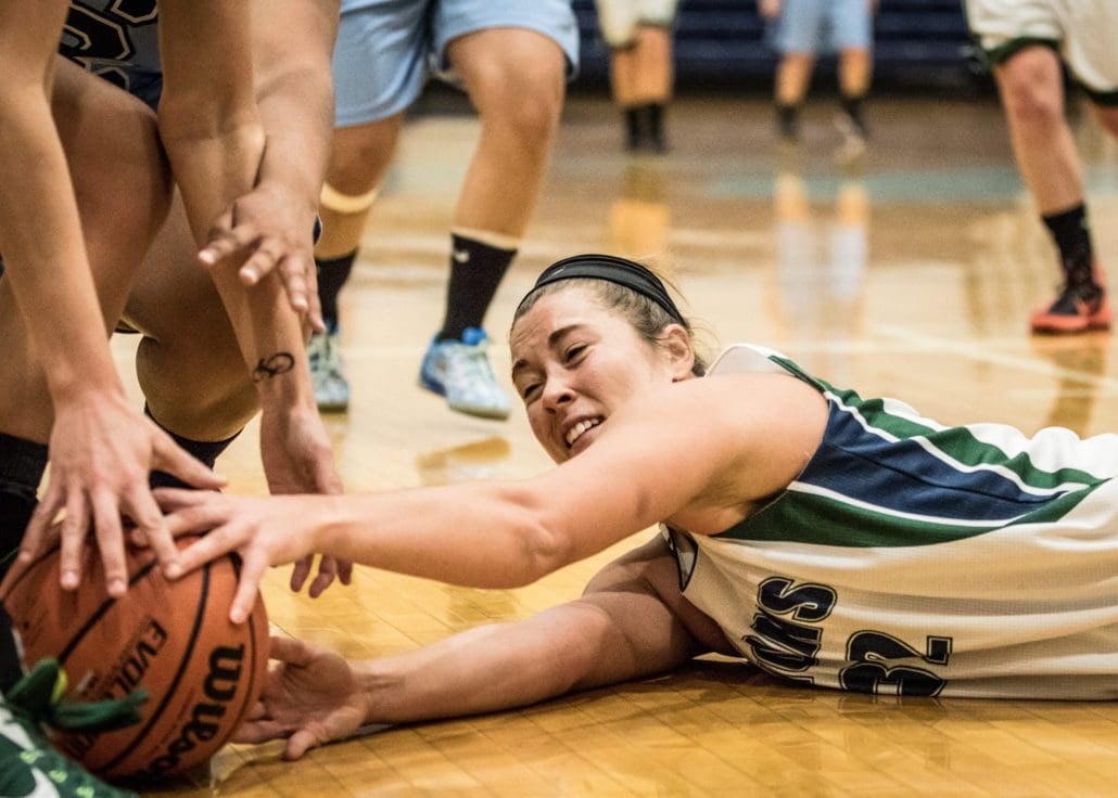 BRAMPTON, ON – Nov. 27, 2016: Christine Fleischer of the Lambton Lions stretches to pass the ball to a teammate while on the ground.