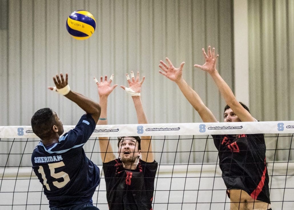 OAKVILLE, ON - Oct. 29, 2016: Shaun Lasala of the Sheridan Bruins attempts to place the ball past two Fanshawe defenders.