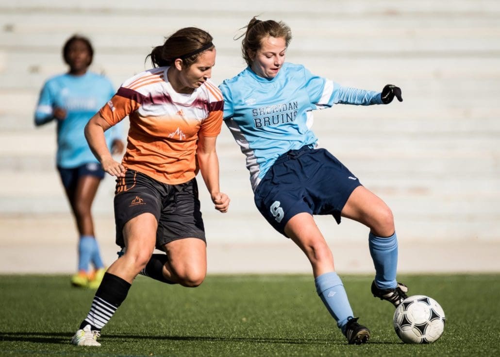 OAKVILLE, ON - Oct. 22, 2016: Two players battle for the ball in a game between the Sheridan Bruins and Mohawk College.